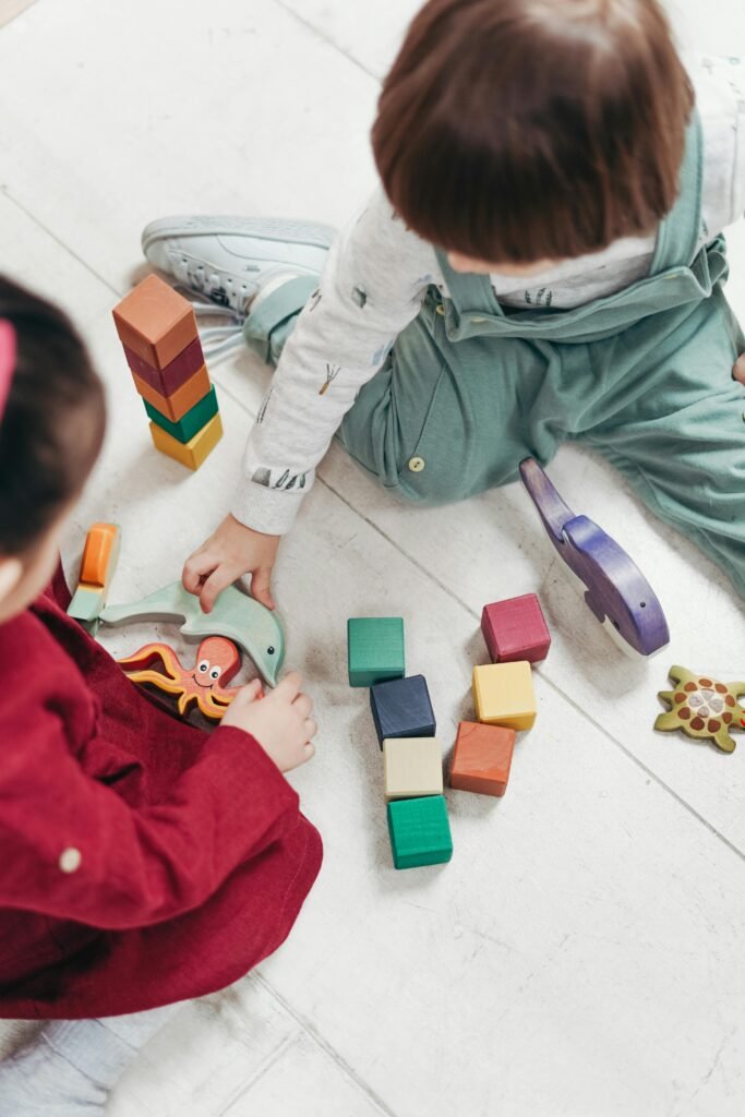 Children playing quietly with blocks – example of calm, mess-free wedding babysitter childcare